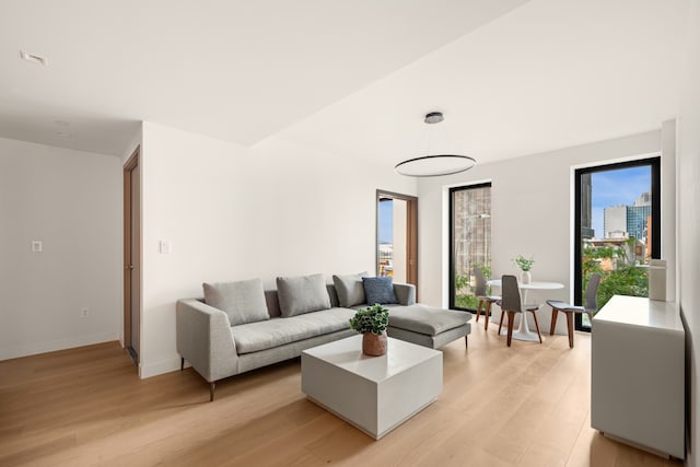 living room featuring baseboards and light wood finished floors