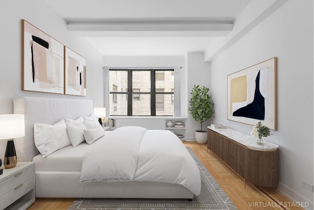 bedroom featuring beam ceiling and baseboards