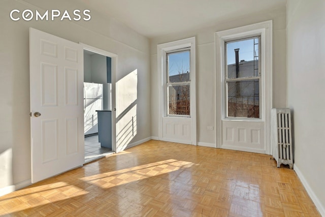 entryway featuring radiator and baseboards