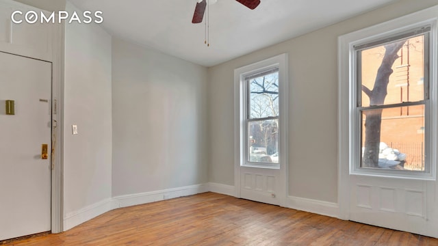 doorway to outside featuring ceiling fan, hardwood / wood-style floors, and baseboards