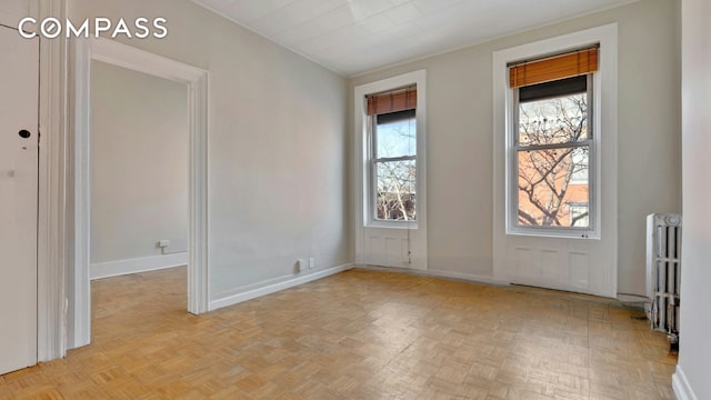 interior space with radiator and baseboards