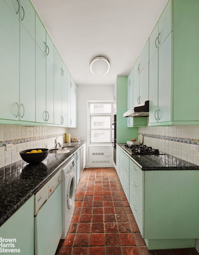 35 Sutton Pl Unit 18F, New York City, NY 10022 - kitchen with a sink, brick floor, washer / clothes dryer, stainless steel appliances, and under cabinet range hood