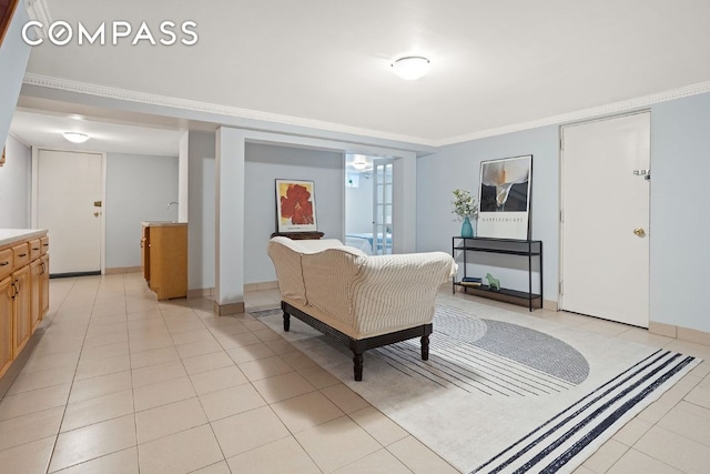 interior space with light tile patterned floors, baseboards, and crown molding