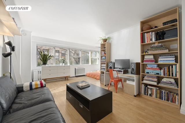 living room with ornamental molding, radiator heating unit, light wood-type flooring, and visible vents