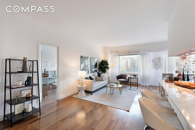 living room with wood finished floors and baseboards