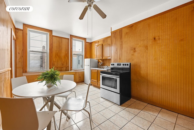 kitchen featuring light tile patterned floors, electric range, visible vents, freestanding refrigerator, and light countertops