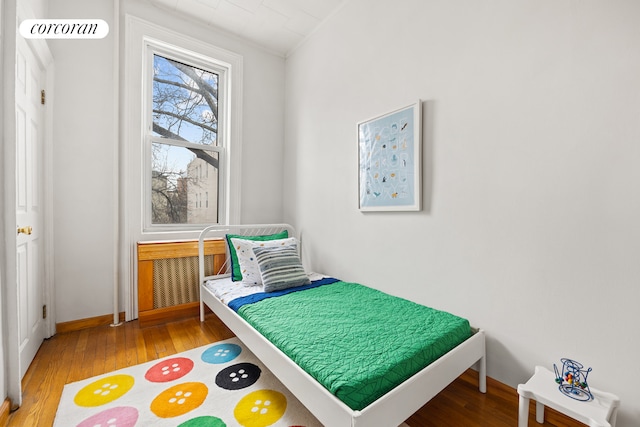 bedroom with wood finished floors and baseboards