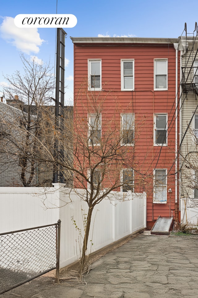 view of side of home featuring fence