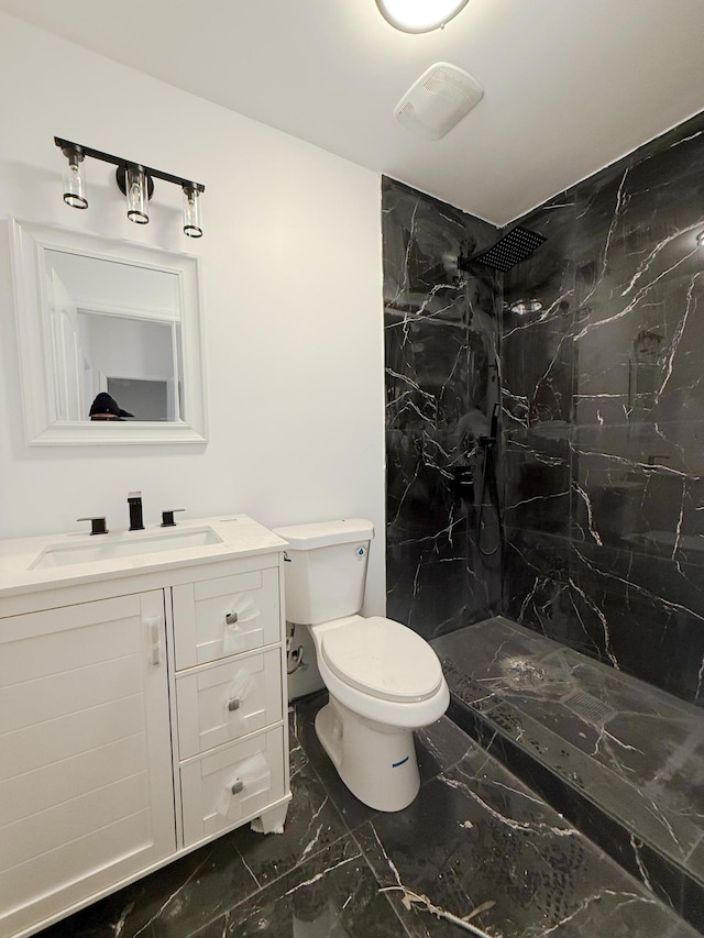 bathroom with a marble finish shower, marble finish floor, toilet, and vanity