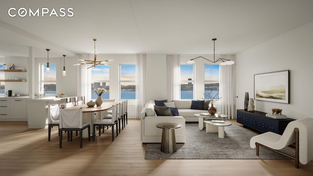 living area with light wood finished floors and an inviting chandelier