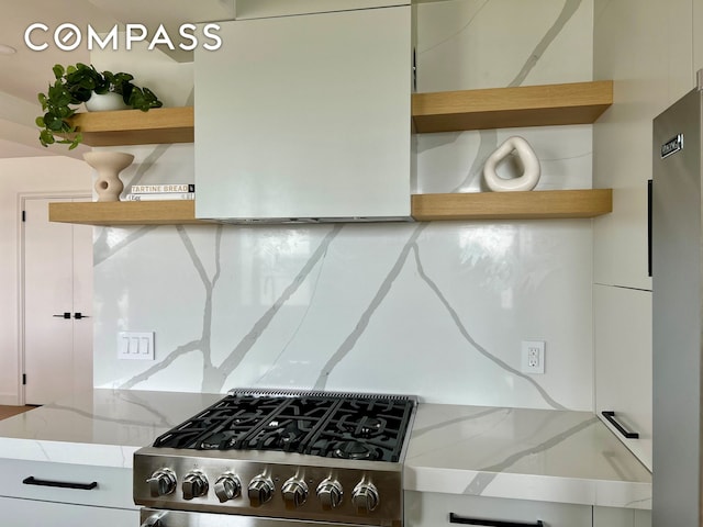 kitchen featuring white cabinets, open shelves, light wood-style flooring, and high quality appliances