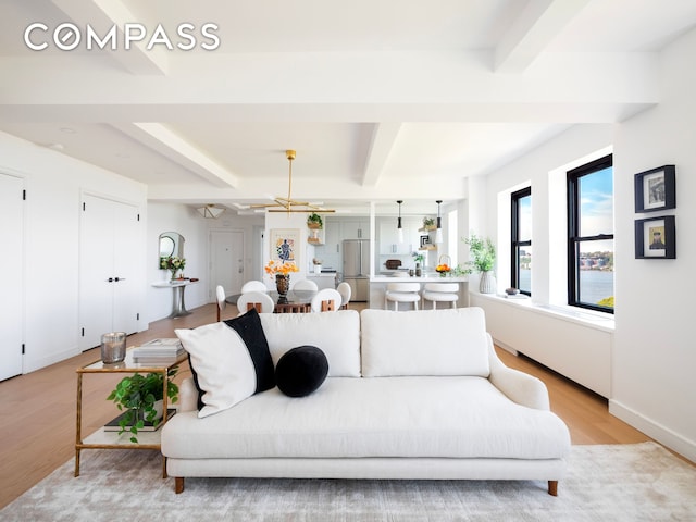230 Riverside Dr Unit 14Ac, New York City, NY 10025 - living room with beam ceiling, light wood-type flooring, and a chandelier