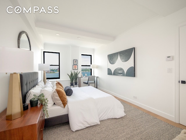 bedroom featuring baseboards and wood finished floors