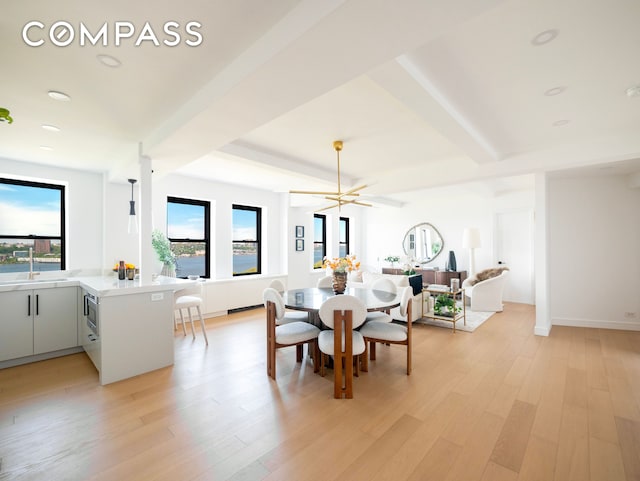 dining area featuring baseboards and light wood-type flooring