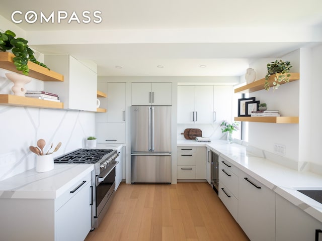 230 Riverside Dr Unit 14Ac, New York City, NY 10025 - kitchen featuring open shelves, premium appliances, light wood-style floors, white cabinetry, and recessed lighting