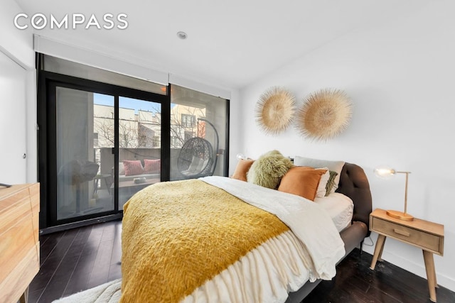 bedroom featuring baseboards, dark wood-style flooring, and access to exterior