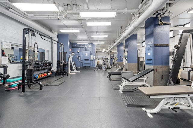 exercise room with concrete block wall