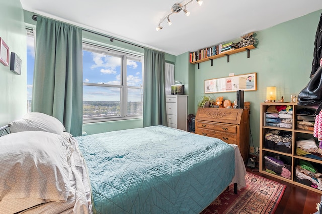 bedroom featuring track lighting