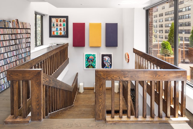 stairway featuring wood finished floors and baseboards