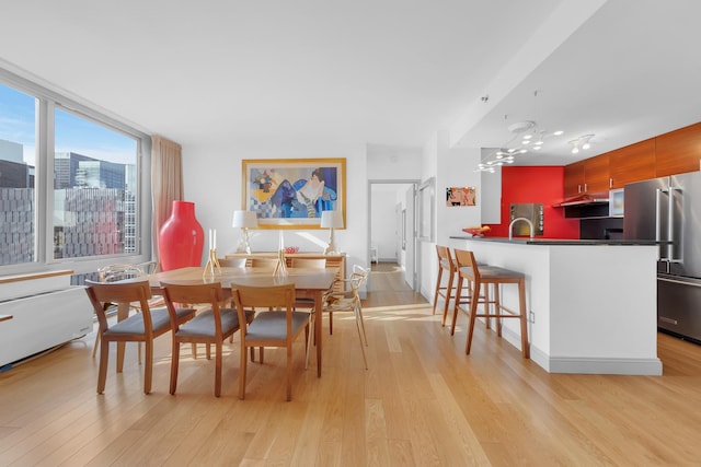 dining area featuring light wood-style flooring