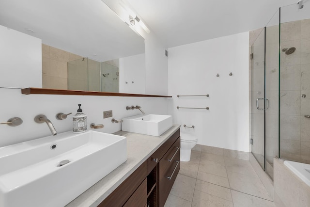 bathroom with tile patterned floors, a sink, toilet, and a shower stall