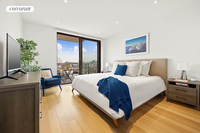 bedroom featuring access to exterior, recessed lighting, visible vents, light wood-style flooring, and expansive windows