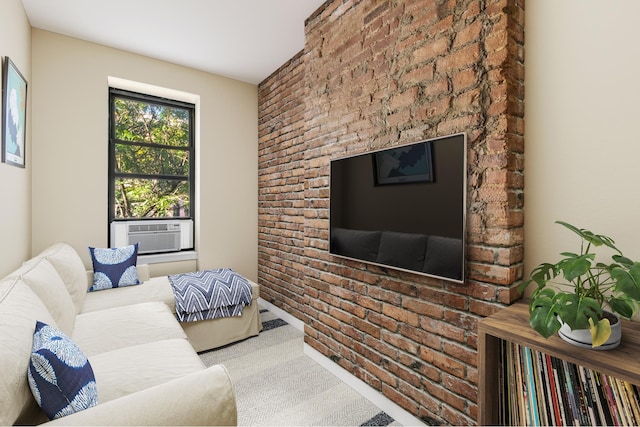 living area featuring brick wall, cooling unit, and carpet flooring