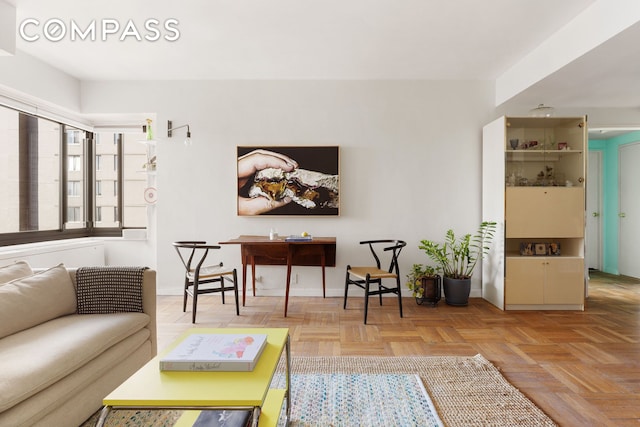 living area featuring baseboards