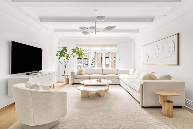 living room with baseboards, beam ceiling, and an inviting chandelier