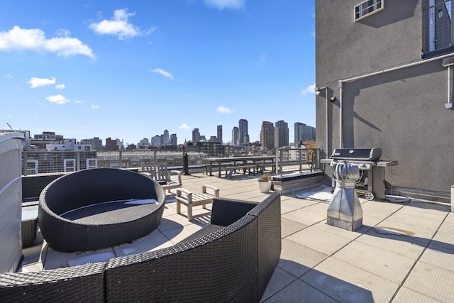 view of patio / terrace featuring a grill and a city view