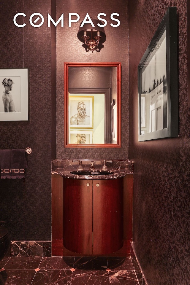 bathroom featuring marble finish floor and vanity