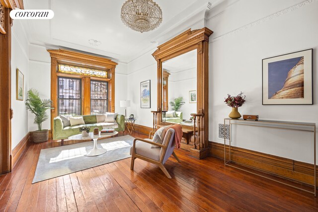 sitting room with baseboards and hardwood / wood-style floors