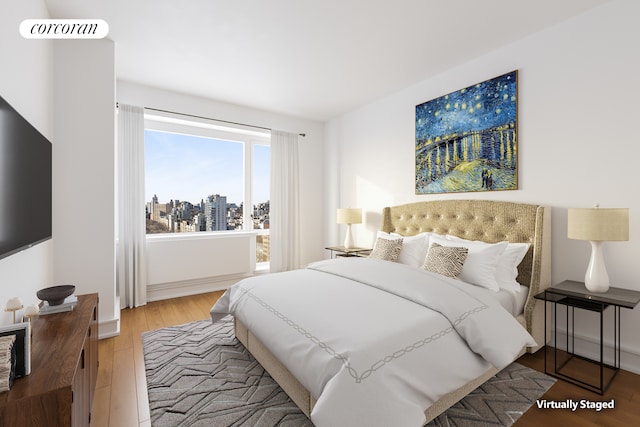 1280 5th Ave Unit 16B, New York City, NY 10029 - bedroom featuring wood finished floors and a view of city
