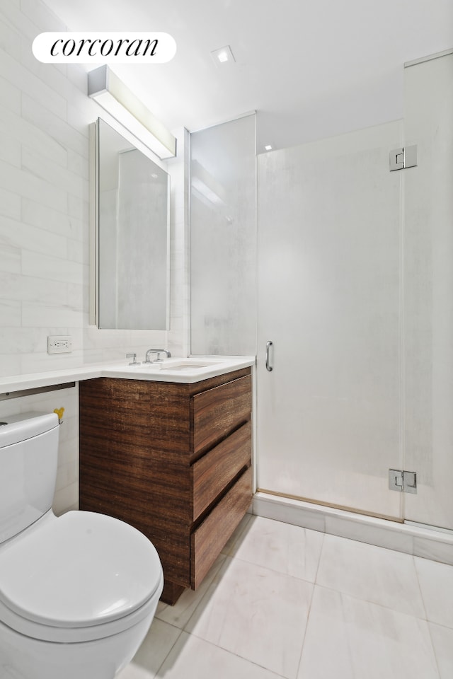 full bathroom with toilet, tile patterned floors, a shower stall, and vanity