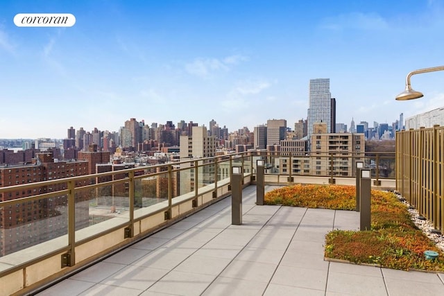 exterior space with a balcony, a view of city, and visible vents