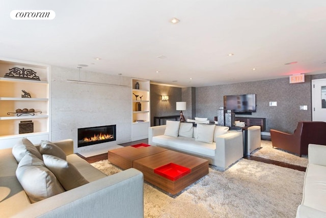 living area with a tile fireplace, recessed lighting, visible vents, built in features, and wallpapered walls