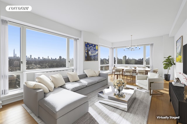 1280 5th Ave Unit 16B, New York City, NY 10029 - living area with a chandelier, hardwood / wood-style flooring, and a skyline view
