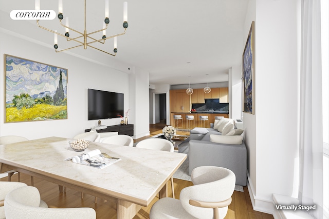 dining space featuring an inviting chandelier, visible vents, and wood finished floors