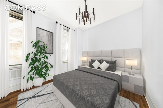 bedroom with baseboards, wood finished floors, and a notable chandelier