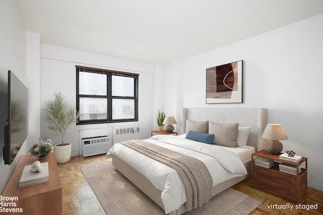 bedroom featuring an AC wall unit and radiator heating unit