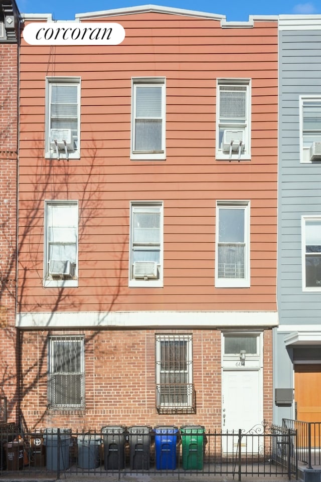 exterior space featuring fence and brick siding