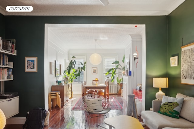 dining area featuring radiator heating unit, wood finished floors, visible vents, and baseboards