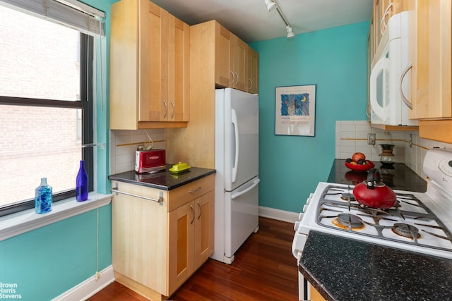 3840 Greystone Ave Unit 2O, New York City, NY 10463 - kitchen with white appliances, dark wood-style flooring, tasteful backsplash, dark countertops, and light brown cabinets