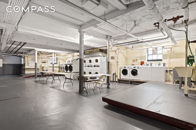 garage featuring stacked washer / dryer and washer and dryer