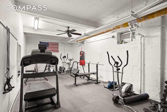 workout area with a textured ceiling and a ceiling fan