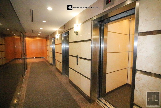 hallway with recessed lighting and elevator