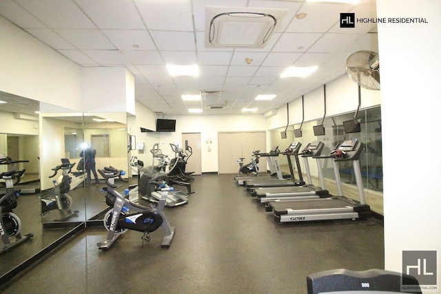 workout area with a paneled ceiling