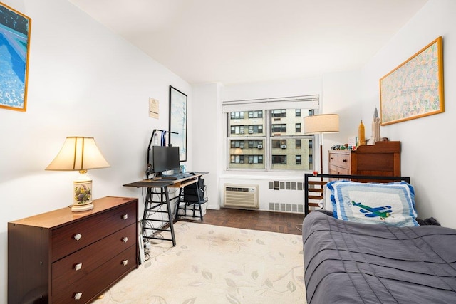 bedroom featuring radiator heating unit, wood finished floors, and a wall mounted AC