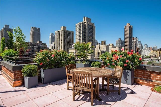 view of patio with a view of city and outdoor dining area