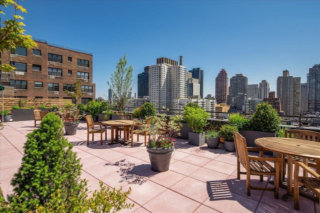 view of patio / terrace with a view of city and outdoor dining space